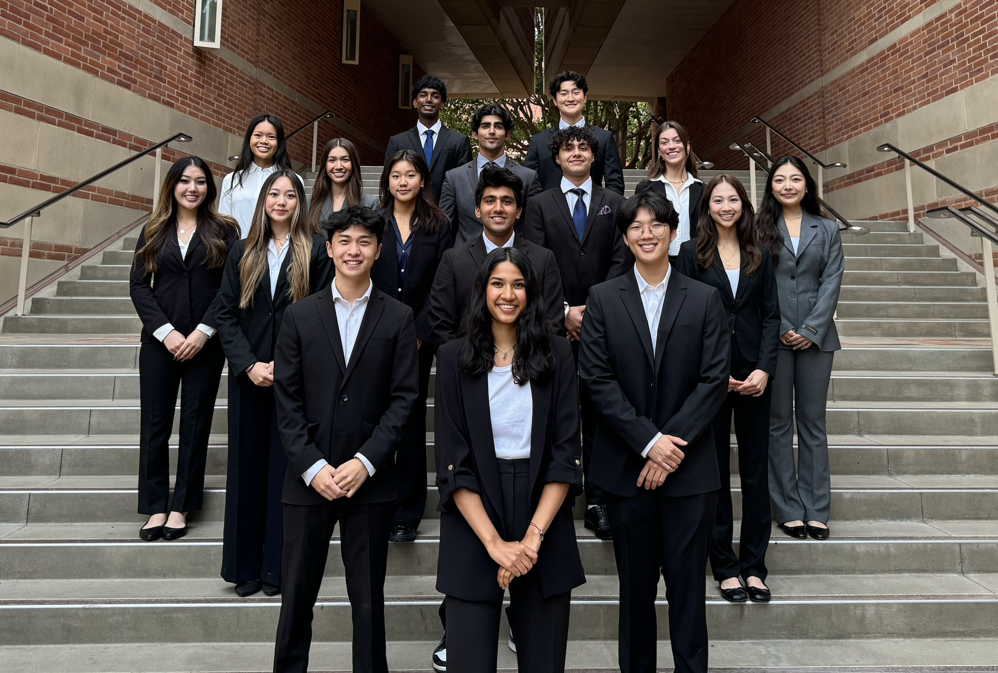 UCLA Delta Sigma Pi brothers in business attire on the steps